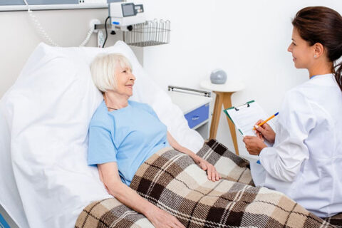 patient lying on the bed and doctor examining the patient