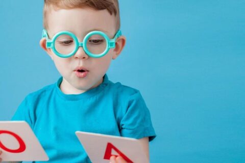 Kids wearing blue t-shirt and playing with letters