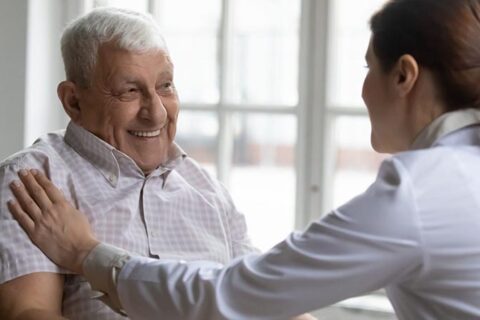 Lady taking care of old man at the home