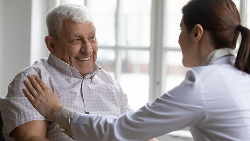 Lady taking care of old man at the home