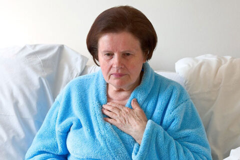 blue color bath clothes wearing lady sitting on the sofa