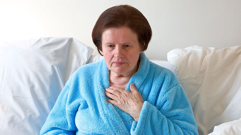 blue color bath clothes wearing lady sitting on the sofa