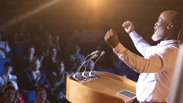 Man giving motivational speech in the conference hall