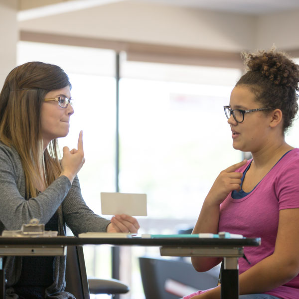 young adult doing speech therapy