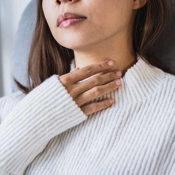 woman touching her throat
