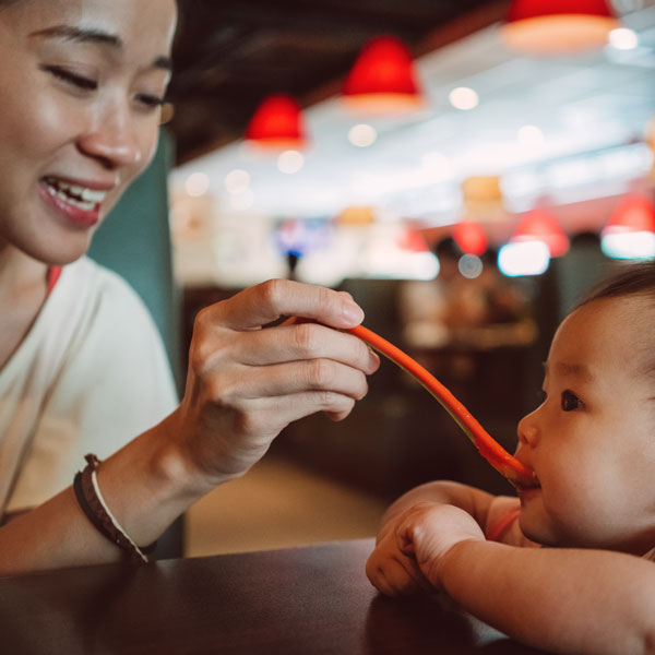 woman feeding her child