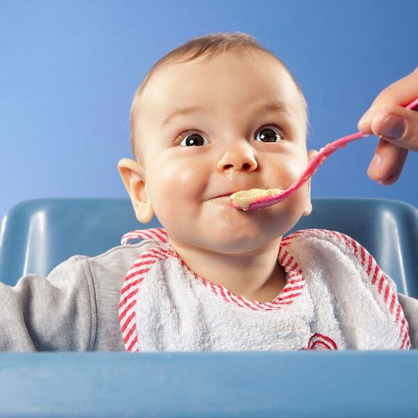 infant being fed baby food